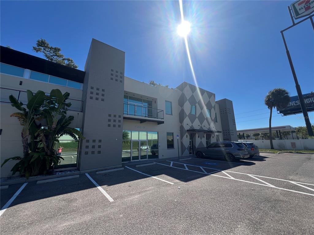 A two-story commercial building with a parking lot and a 7-Eleven sign in the background — 4007 N TALIAFERRO AVENUE UNIT B-C-D, TAMPA, FL