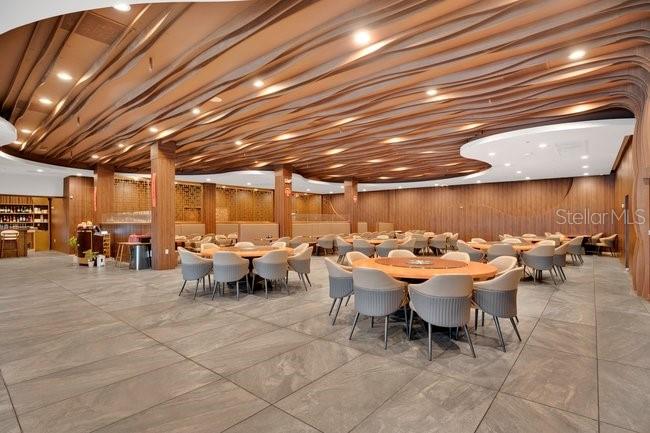 A large dining room features a wavy wood-slat ceiling and numerous round tables with chairs — 1101 E COLONIAL DRIVE, ORLANDO, FL