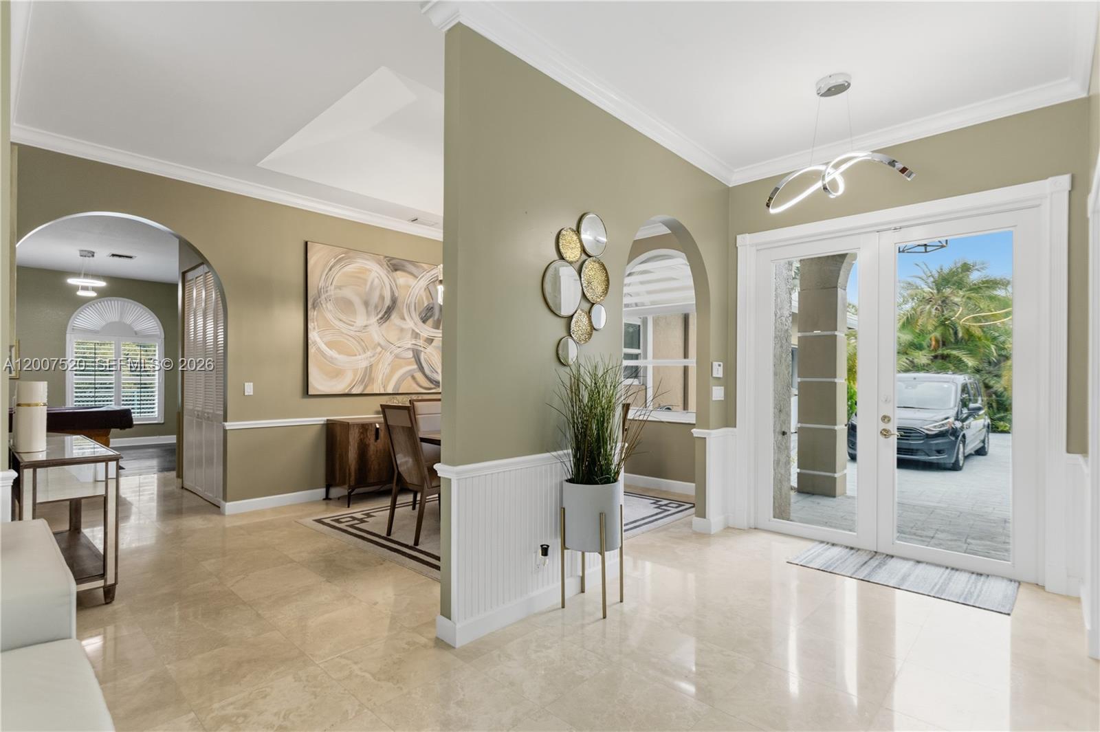 An entryway with tile floors, an arched opening, and a view into a dining room — 12343 NW 19th St, Plantation FL 33323, PLANTATION, FL