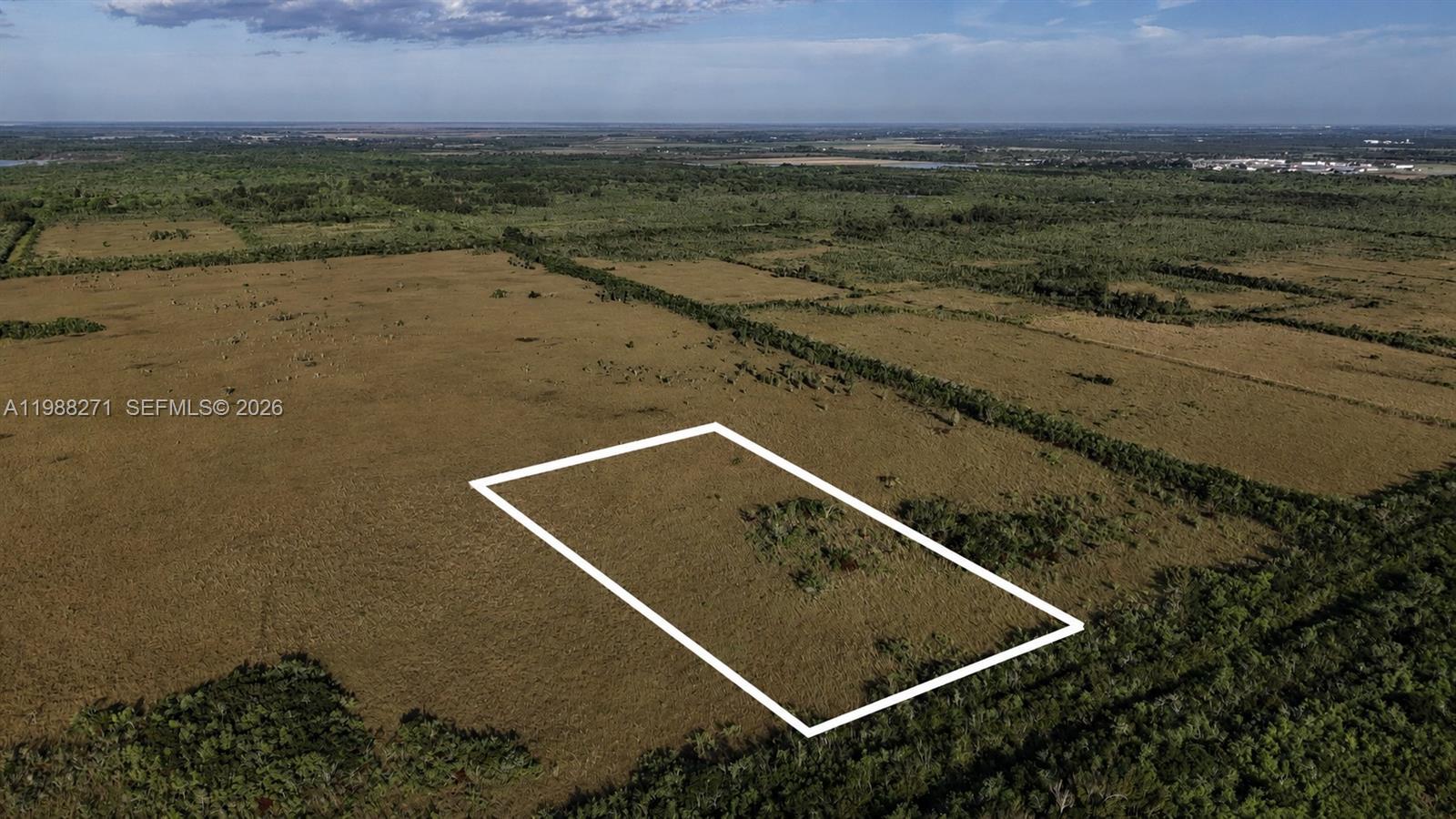 An aerial view shows a rectangular plot of land outlined in white within a field — 0 Unknown Road, Unincorporated Dade County FL 33034, UNINCORPORATED DADE COUNTY, FL