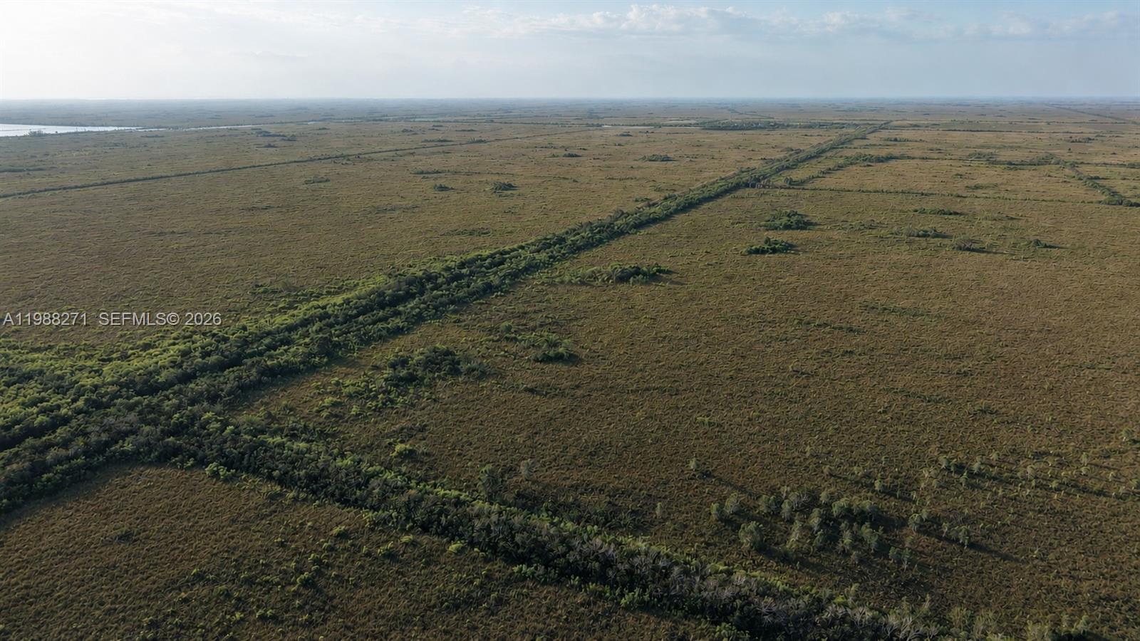 An aerial view shows a vast, flat expanse of grassy wetlands with scattered shrubs and trees — 0 Unknown Road, Unincorporated Dade County FL 33034, UNINCORPORATED DADE COUNTY, FL