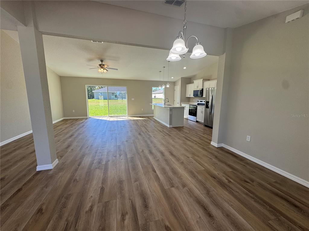 A single-story house with a gray exterior, a two-car garage, and a concrete walkway — 8781 N QUARRY DRIVE, CITRUS SPRINGS, FL