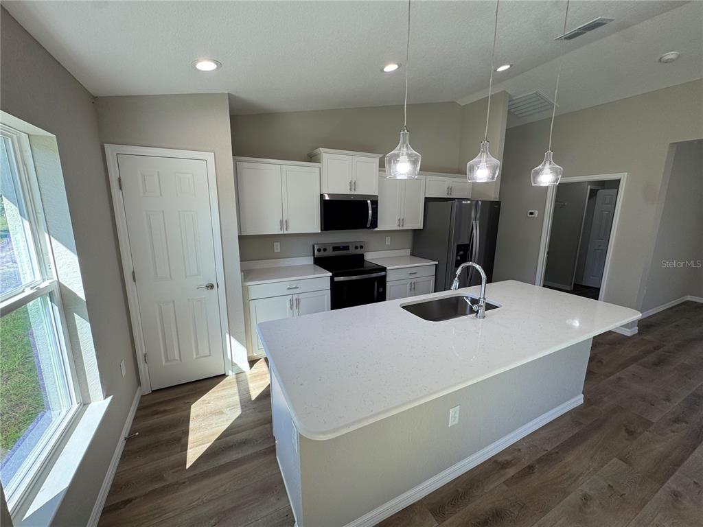 This floor plan shows a three-bedroom house with a two-car garage and a central kitchen — 8781 N QUARRY DRIVE, CITRUS SPRINGS, FL