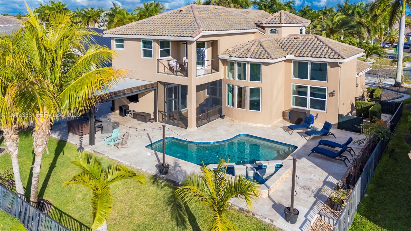 An aerial view of a two-story house with a pool, patio, and palm trees — 3240 SW 190th Ave, Miramar FL 33029, MIRAMAR, FL