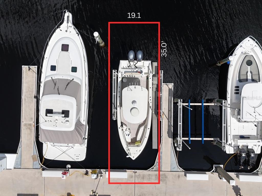 An aerial view shows a boat docked in a slip with dimensions marked 19.1 by 35.0 feet — 102 RIVIERA DUNES WAY UNIT N-20, PALMETTO, FL