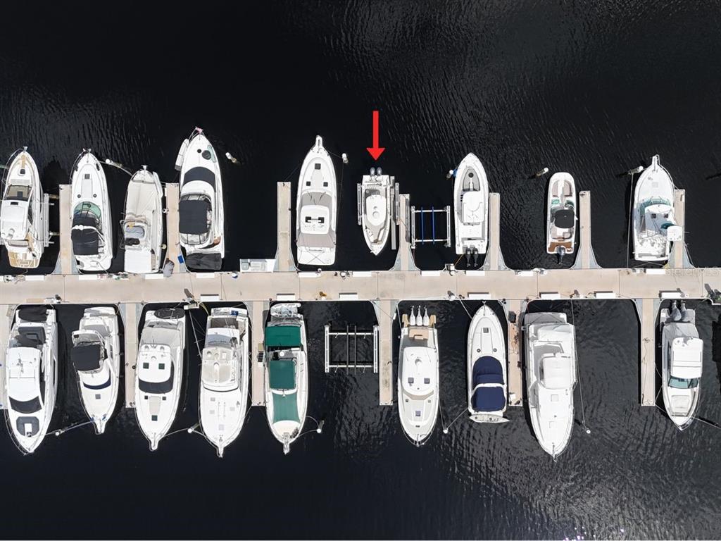 An aerial view shows a row of boats docked at a marina pier — 102 RIVIERA DUNES WAY UNIT N-20, PALMETTO, FL