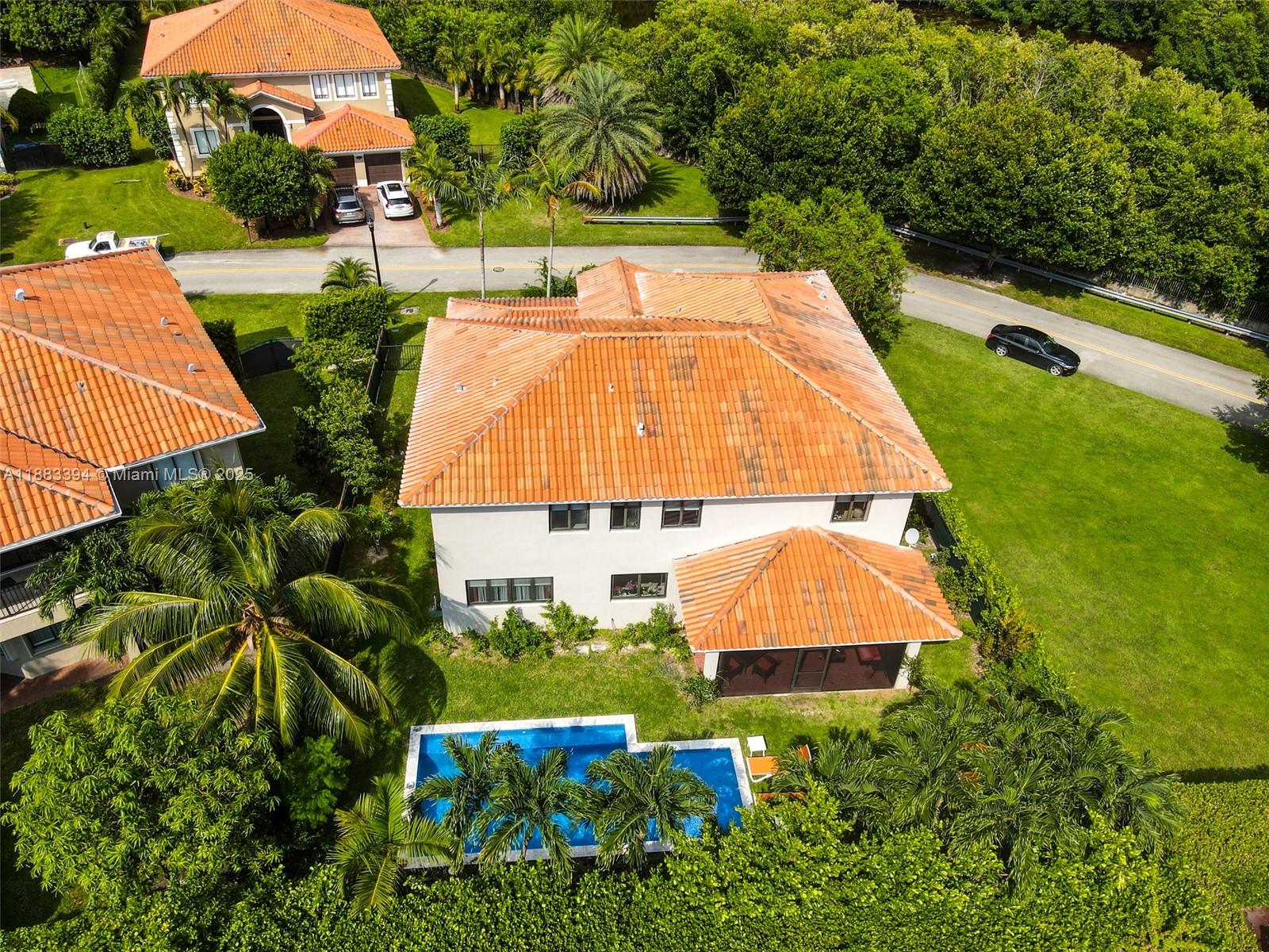 An aerial view shows a two-story house with a tiled roof, pool, and surrounding landscaping — 7408 SW 189th St, Cutler Bay FL 33157, CUTLER BAY, FL