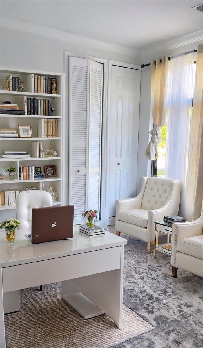 A home office features a white desk, a bookshelf, two armchairs, and floor-to-ceiling closets — 7408 SW 189th St, Cutler Bay FL 33157, CUTLER BAY, FL