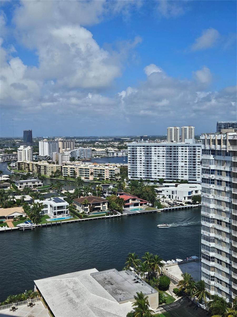 An elevated view of a canal, waterfront homes, and high-rise apartment buildings under a sky — 1985 S Ocean Drive # 20d, Hallandale Beach FL 33009, HALLANDALE BEACH, FL