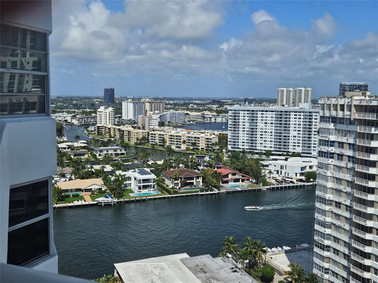 An elevated view of a canal, residential buildings, and houses under a partly cloudy sky — 1985 S Ocean Drive # 20d, Hallandale Beach FL 33009, HALLANDALE BEACH, FL