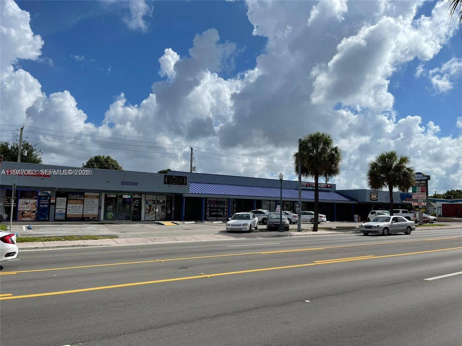 A strip mall with multiple storefronts sits behind a parking lot along a paved road — 4757 SW 8th St # 4747, Miami FL 33134, MIAMI, FL
