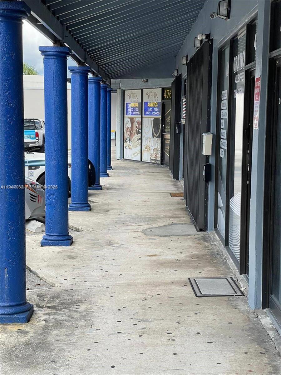 A covered outdoor walkway features a row of blue columns in front of storefronts — 4757 SW 8th St # 4747, Miami FL 33134, MIAMI, FL