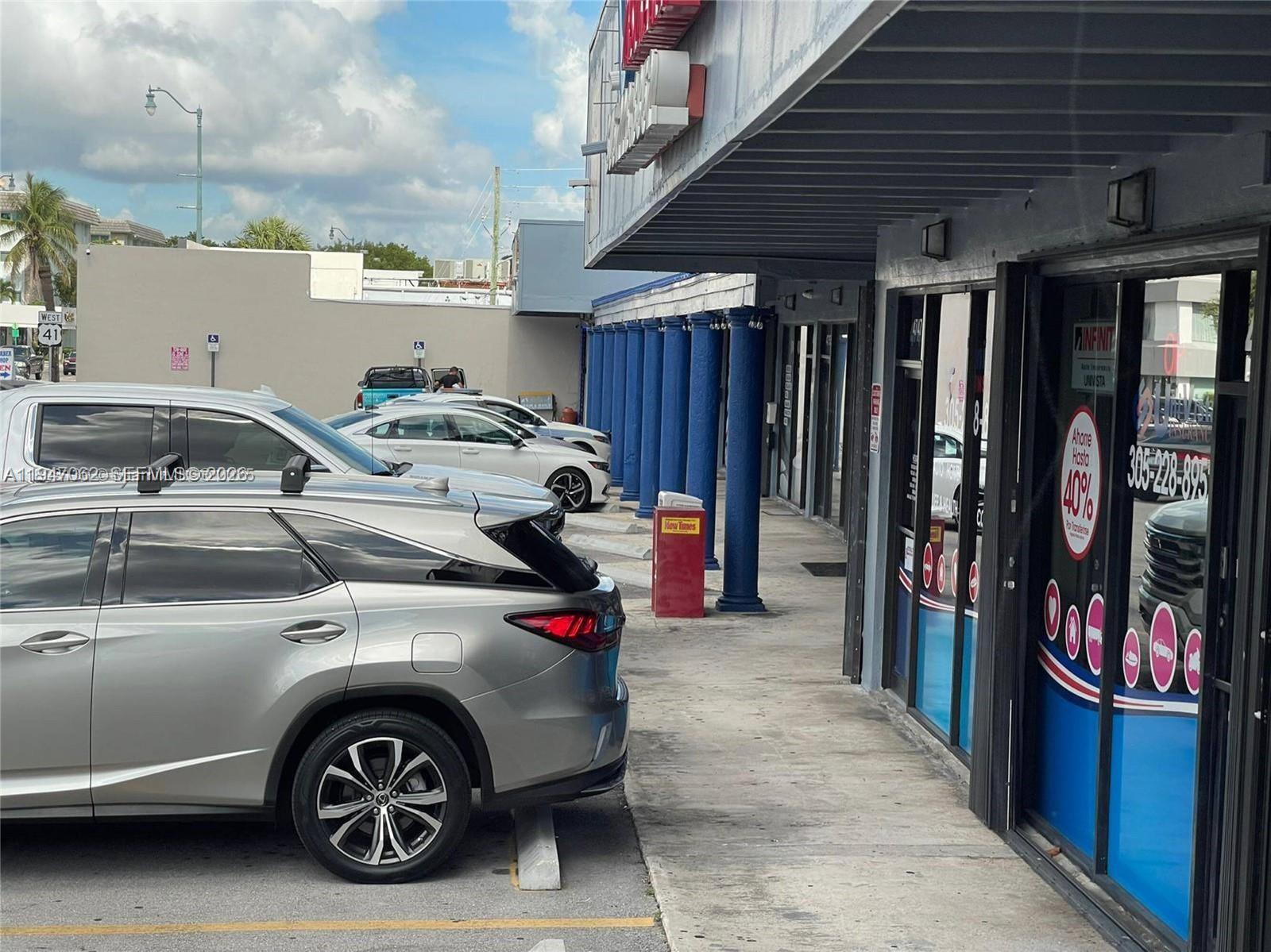 A silver SUV is parked in front of a commercial building with blue columns — 4757 SW 8th St # 4747, Miami FL 33134, MIAMI, FL