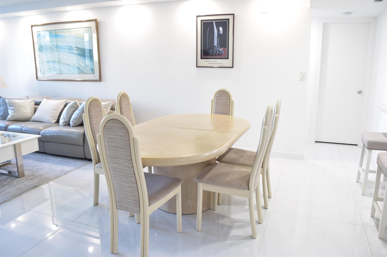 A dining area features a light wood table with six upholstered chairs on white tile — 3420 S Ocean Boulevard # 7o, Highland Beach FL 33487, HIGHLAND BEACH, FL