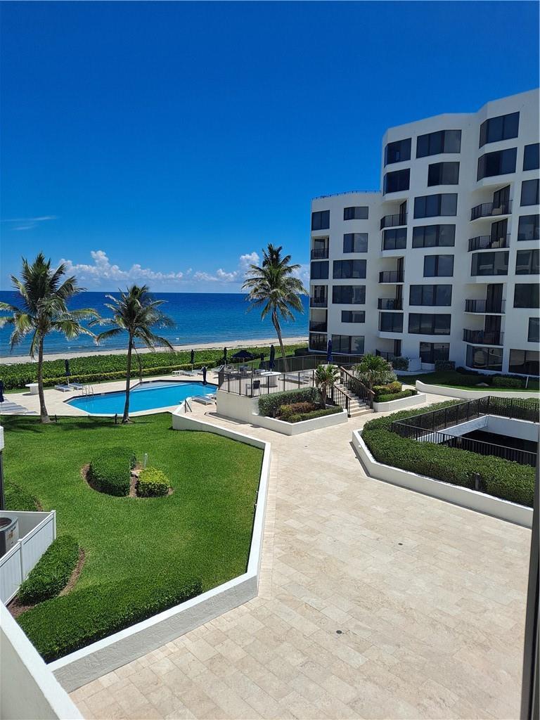 An elevated view of a coastal apartment building with a swimming pool and landscaped grounds — 2565 S Ocean Boulevard # 201n, Highland Beach FL 33487, HIGHLAND BEACH, FL