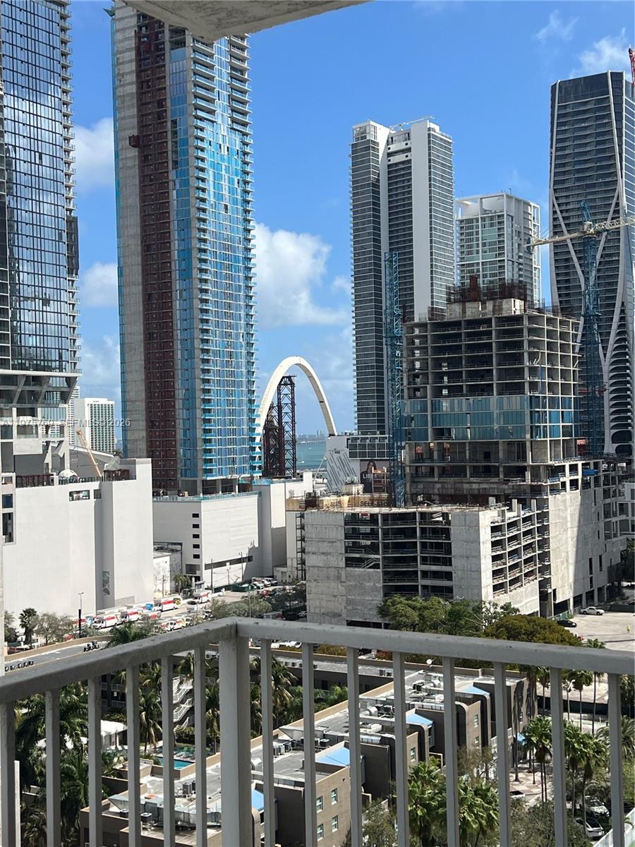 A balcony view overlooks a dense urban skyline with several high-rise buildings under construction — 850 N Miami Ave # 1808, Miami FL 33136, MIAMI, FL