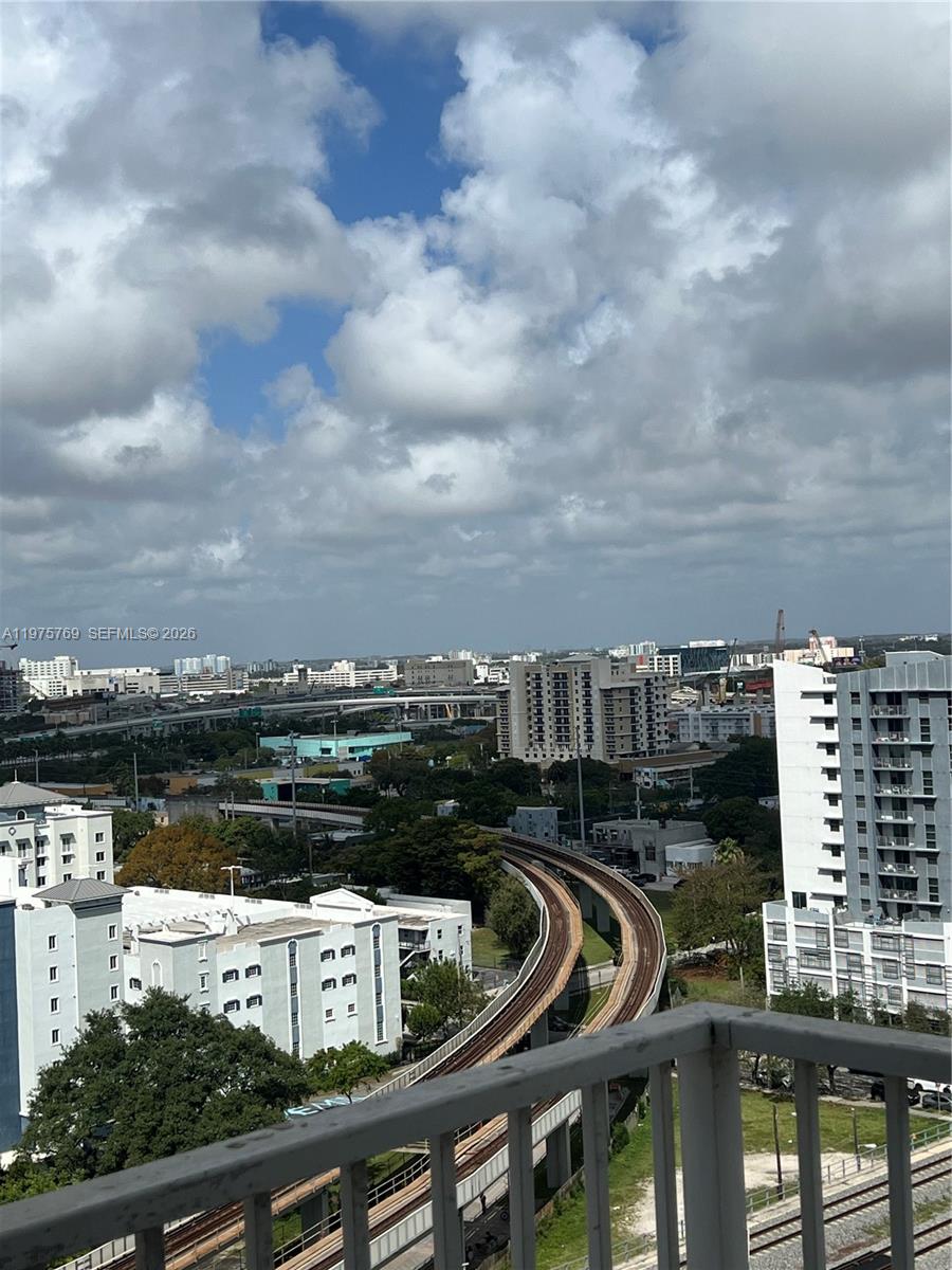 An elevated view shows a curved train track winding through a city with buildings — 850 N Miami Ave # 1808, Miami FL 33136, MIAMI, FL