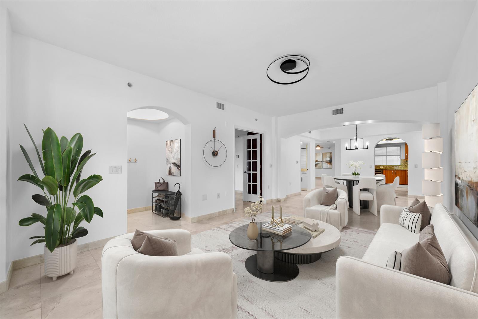 A bright, open-concept living room features white walls, tile flooring, and modern neutral furnishings — 2051 SE 3rd Street, Deerfield Beach FL 33441, DEERFIELD BEACH, FL