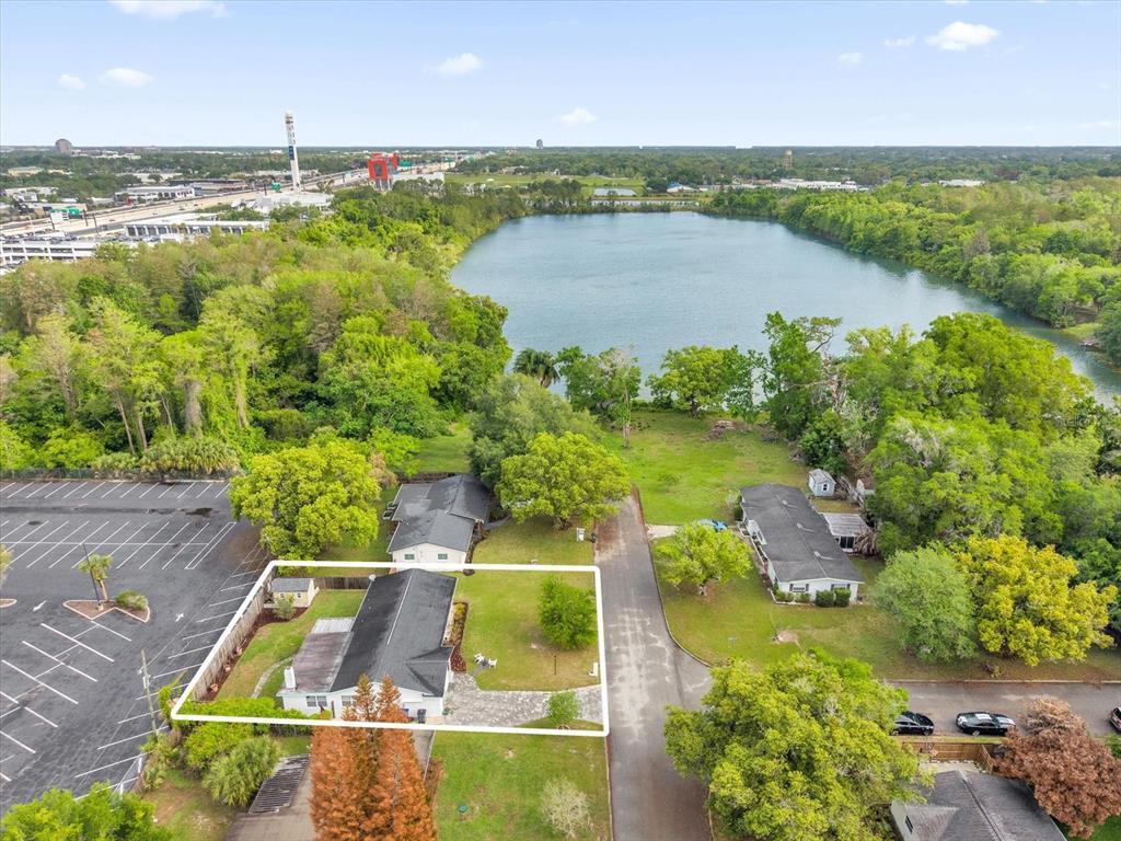 An aerial view shows a house with a white outline situated near a lake — 950 HANOVER AVENUE, WINTER PARK, FL