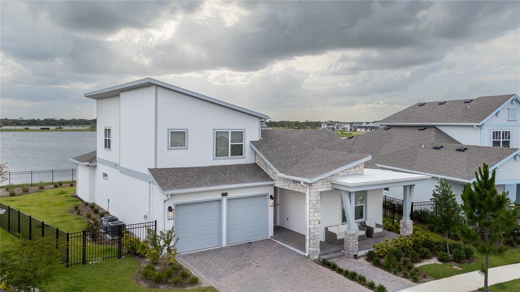 An aerial view of a two-story house with a stone-accented porch and two-car garage — 10044 BALLAST DRIVE, ORLANDO, FL