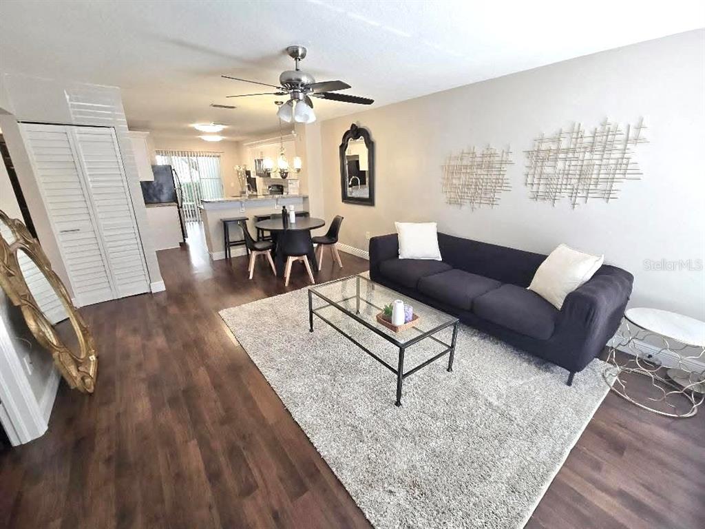 The exterior of a two-story apartment building features purple doors and a concrete staircase — 7910 HARDWICK DRIVE UNIT 713, NEW PORT RICHEY, FL