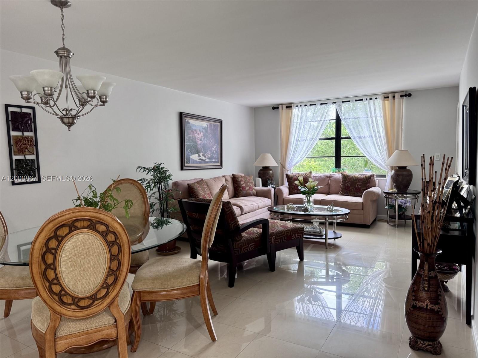 A living and dining room with tile floors, a glass-topped table, and neutral furniture — 10850 N Kendall Dr # 414, Miami FL 33176, MIAMI, FL