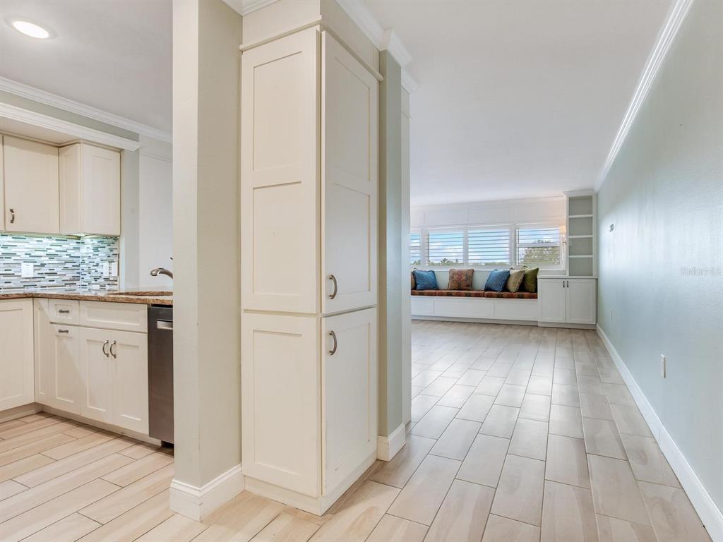 A kitchen with light cabinets and a tiled floor opens into a living area — 4141 BAYSHORE BOULEVARD UNIT 505, TAMPA, FL