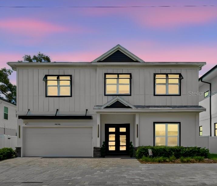 A two-story white modern farmhouse with a two-car garage and a paved driveway — 4022 W BAY TO BAY BOULEVARD, TAMPA, FL