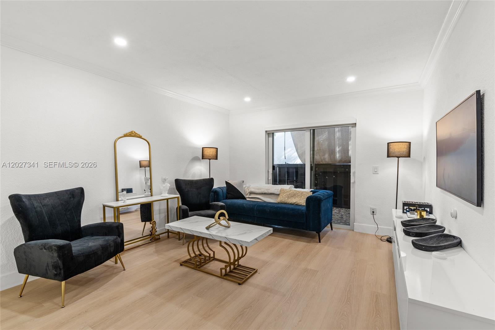 A living room features a blue sofa, two black armchairs, and a marble coffee table — 10780 N Kendall Dr # E7, Miami FL 33176, MIAMI, FL