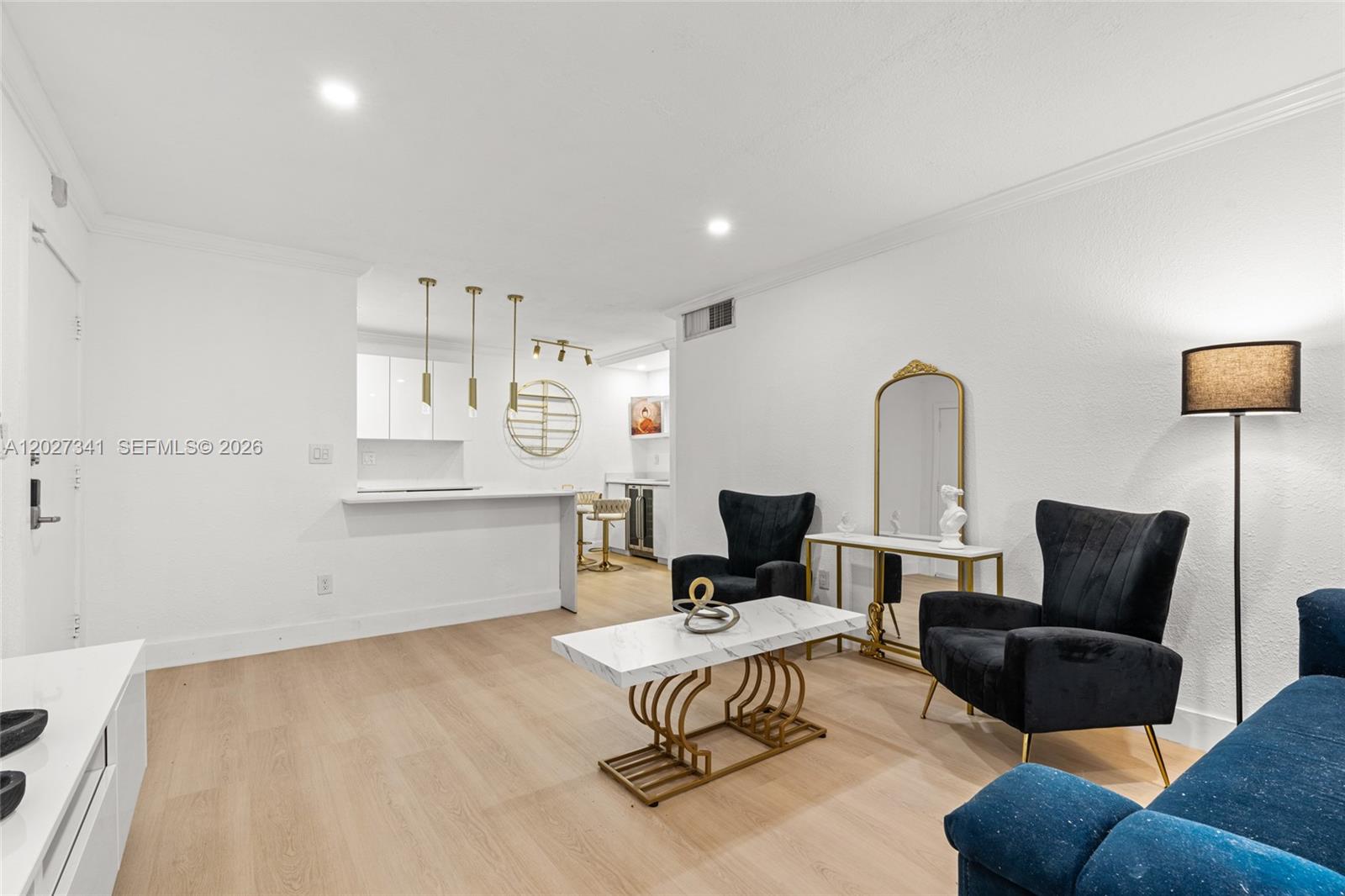 A living room features light wood floors, two black armchairs, and a marble coffee table — 10780 N Kendall Dr # E7, Miami FL 33176, MIAMI, FL