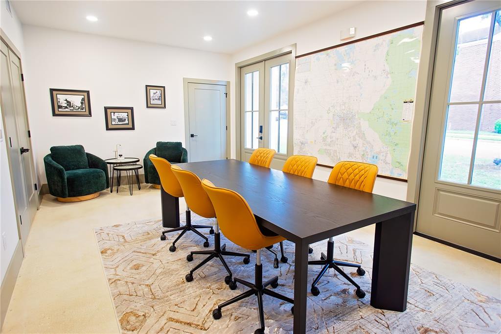 A conference room features a dark table, yellow chairs, a large wall map, and rug — 521 SE 2ND STREET, OCALA, FL