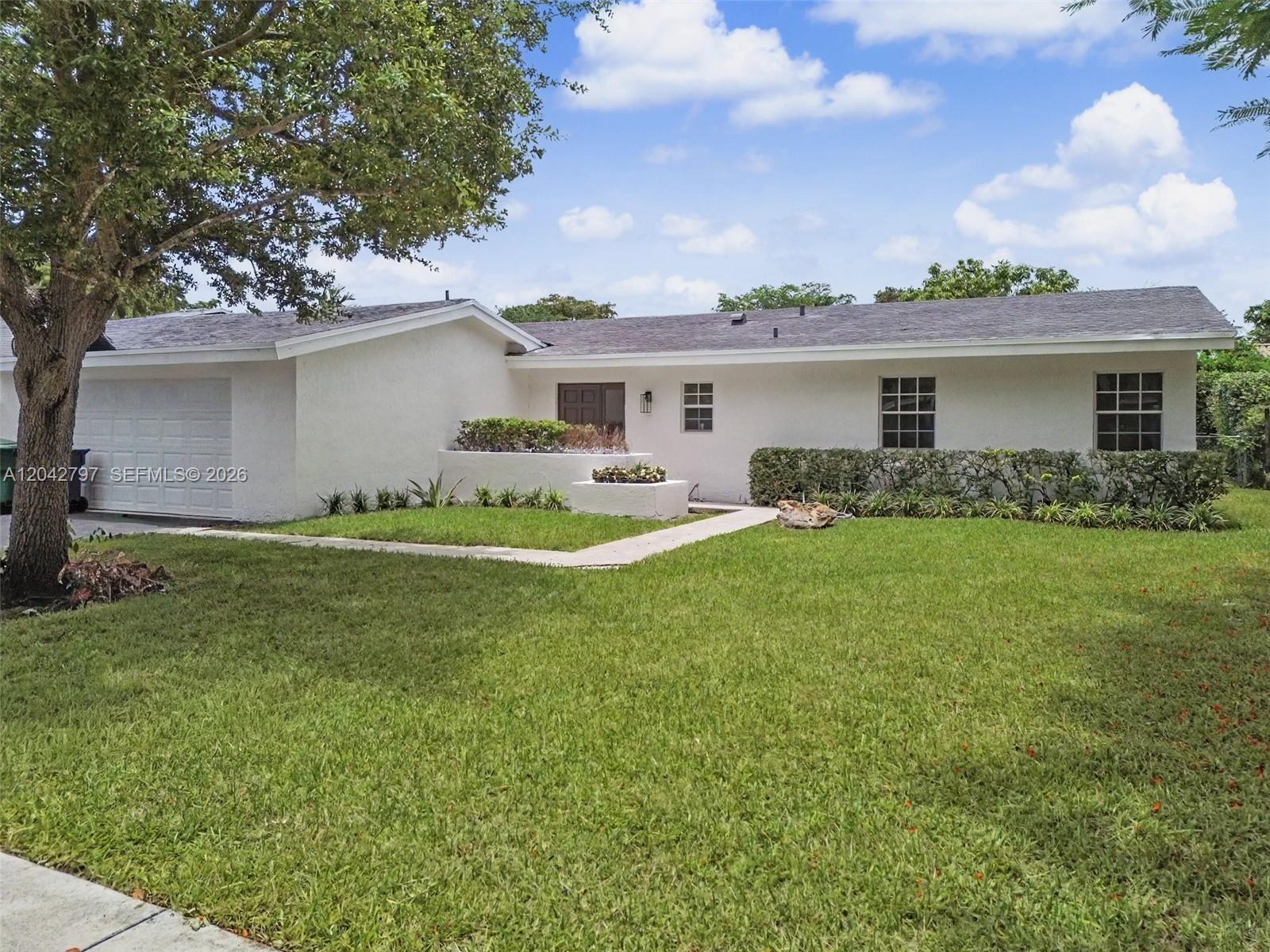 A single-story white house with a garage, a front lawn, and a concrete walkway — 10262 SW 127th Pl, Miami FL 33186, MIAMI, FL