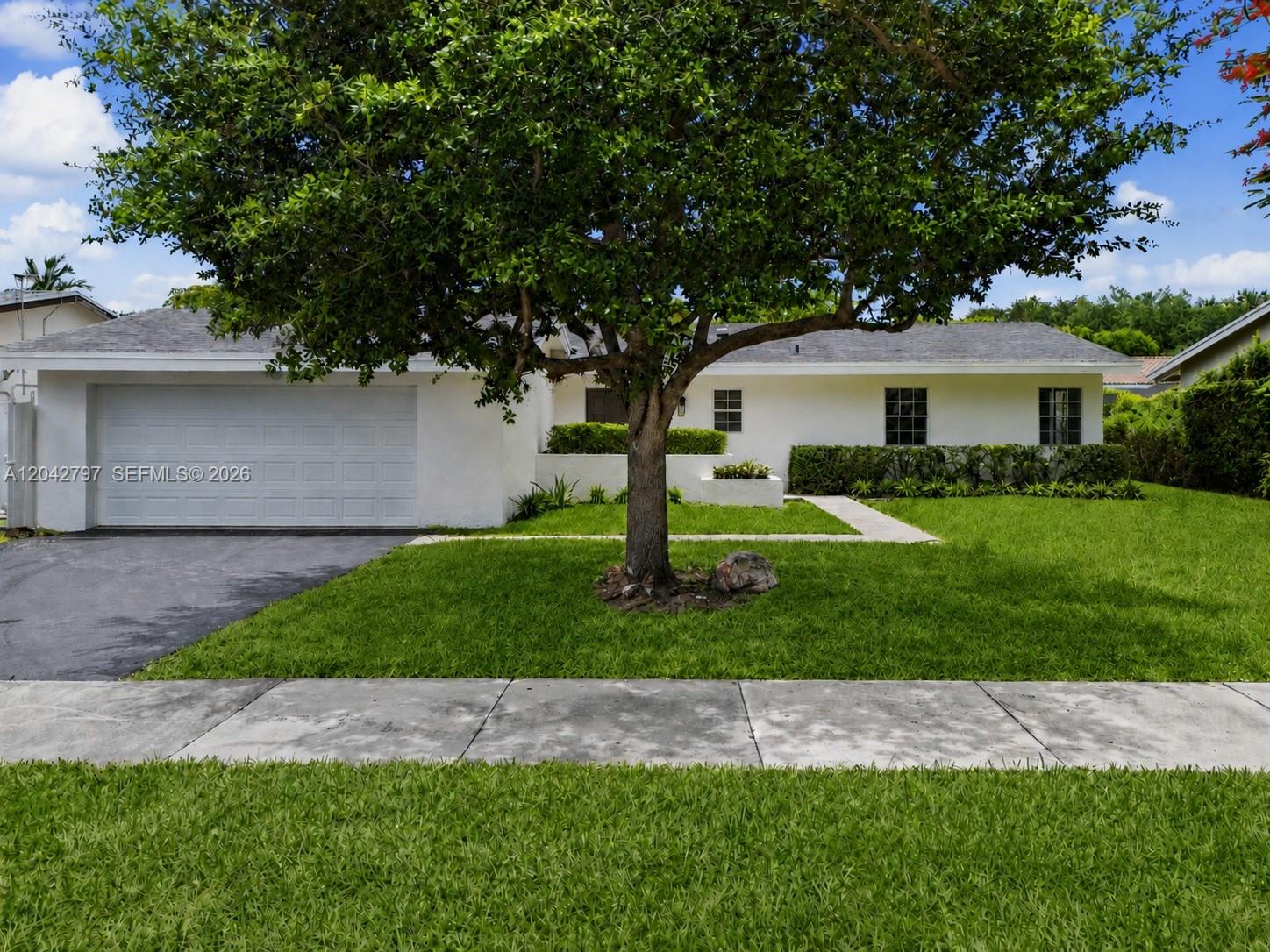 An open-concept living and dining area features a wood-beamed ceiling and tile flooring — 10262 SW 127th Pl, Miami FL 33186, MIAMI, FL