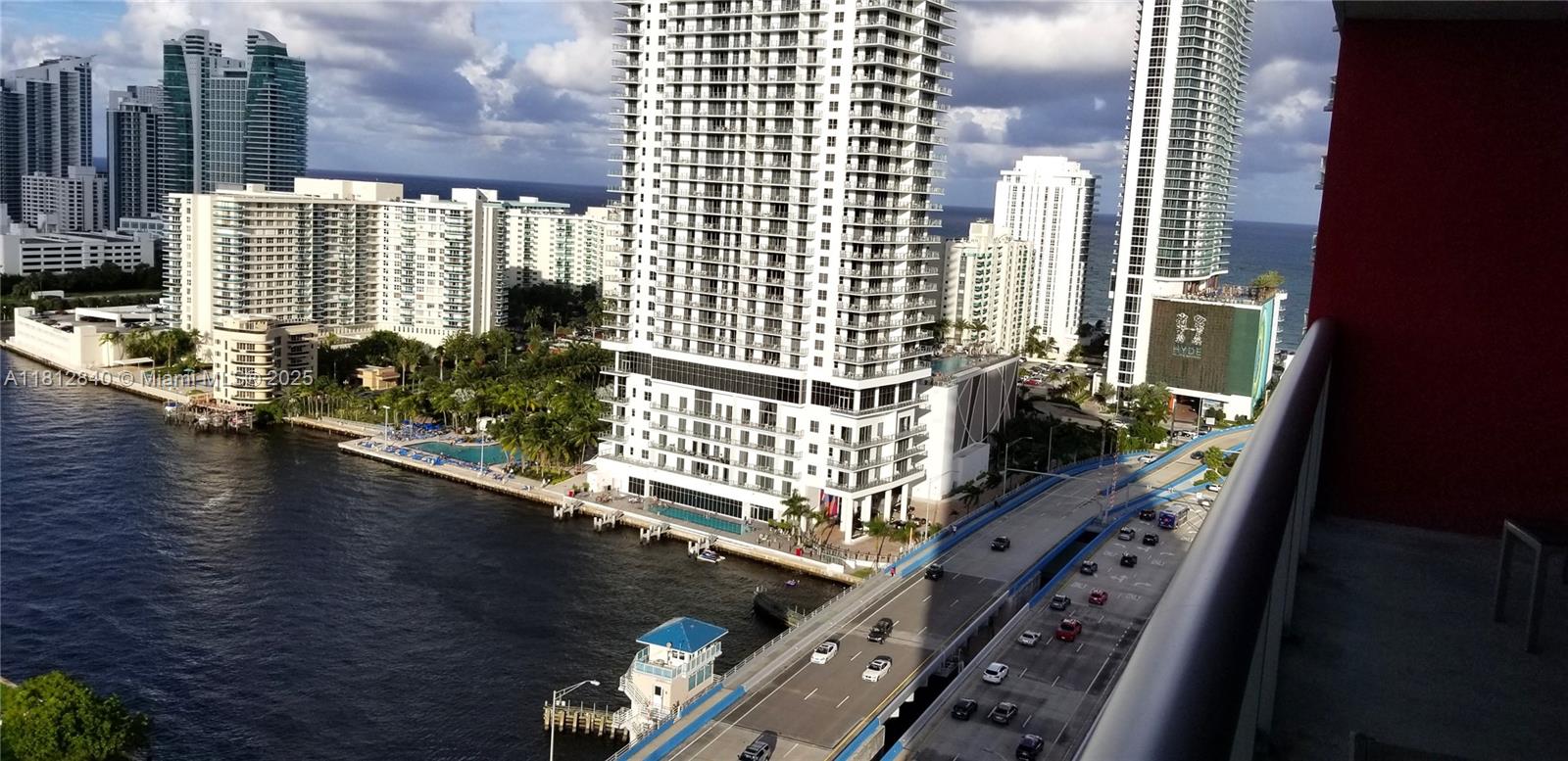 An elevated view shows a coastal city skyline, a bridge, and high-rise apartment buildings — 2602 E Hallandale Beach Blvd # R2010, Hallandale Beach FL 33009, HALLANDALE BEACH, FL