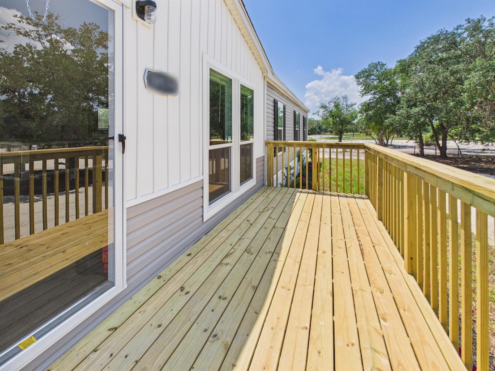 An aerial view shows a house with a deck and pond on a wooded lot — 18574 NW 284th Street, Okeechobee FL 34972, OKEECHOBEE, FL