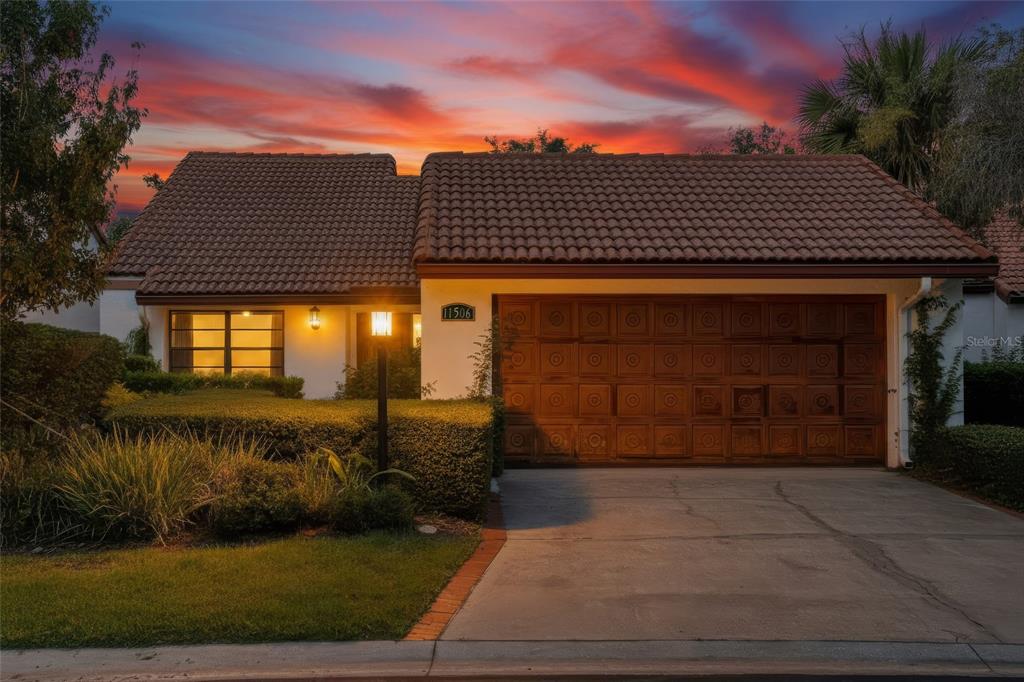 A modern kitchen features white cabinetry, stainless steel appliances, and light wood flooring — 11506 ORILLA DEL RIO PLACE, TEMPLE TERRACE, FL