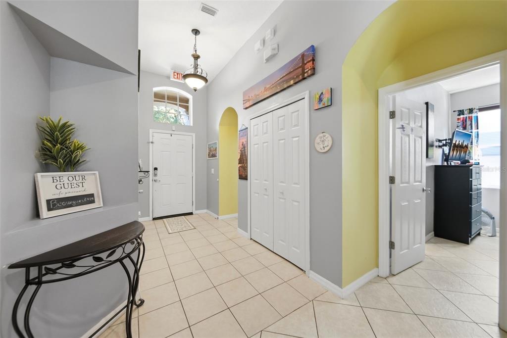 An entryway features tile flooring, a white front door, a closet, and an arched doorway — 429 ORISTA DRIVE, DAVENPORT, FL