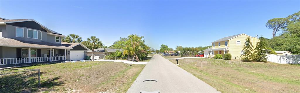 A street view showing two houses on opposite sides of a paved road — 629 GAINES STREET, PORT CHARLOTTE, FL