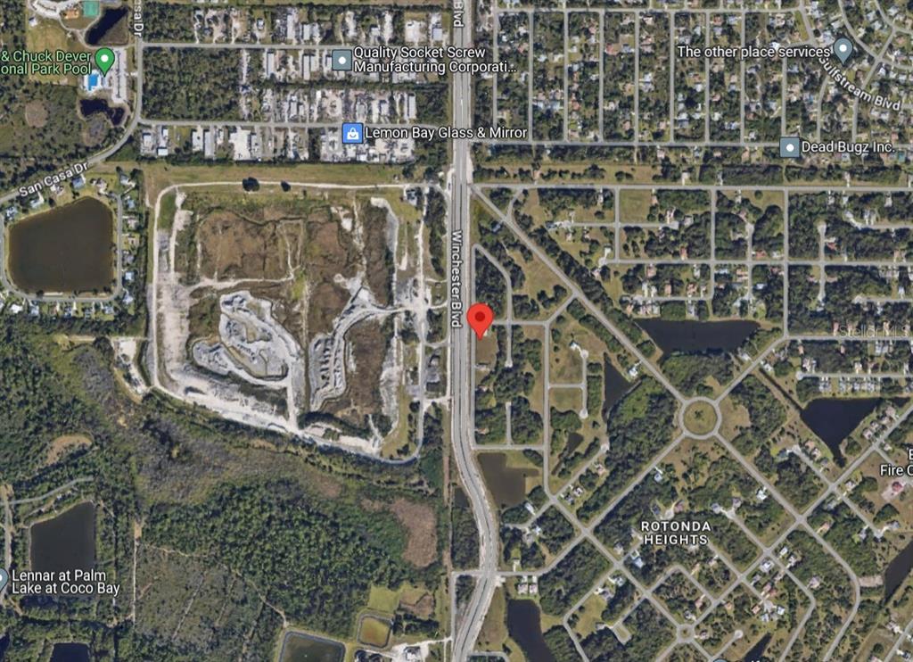 This is an aerial map view of a wooded lot located along Winchester Boulevard — 139 SESAME ROAD W, ROTONDA WEST, FL