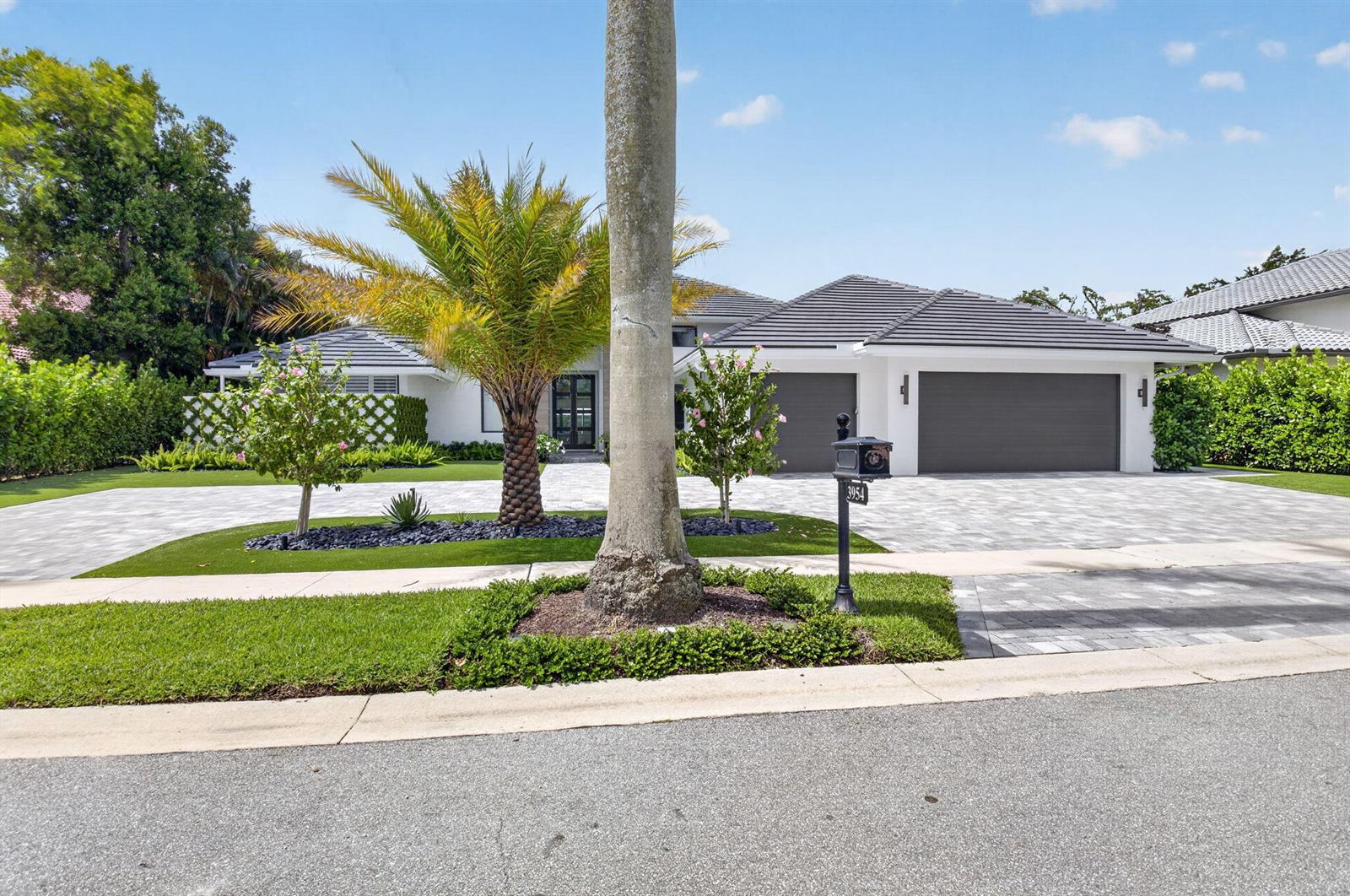 A single-story house with a gray tiled roof, white exterior, and a paved driveway — 3954 NW 52nd Street, Boca Raton FL 33496, BOCA RATON, FL