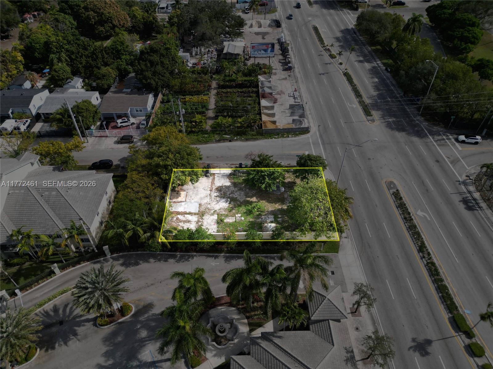 An aerial view shows a vacant, rectangular lot outlined in yellow near a busy road — 1905 NW 79th St, Miami FL 33147, MIAMI, FL