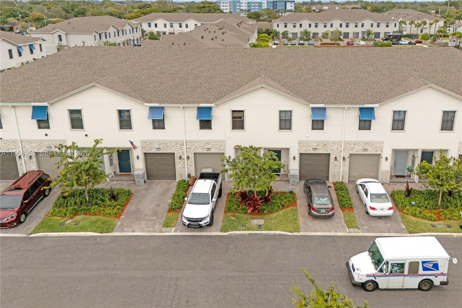 An aerial view shows a row of townhouses with driveways, parked cars, and landscaping — 369 NW 8th Ct, Pompano Beach FL 33060, POMPANO BEACH, FL
