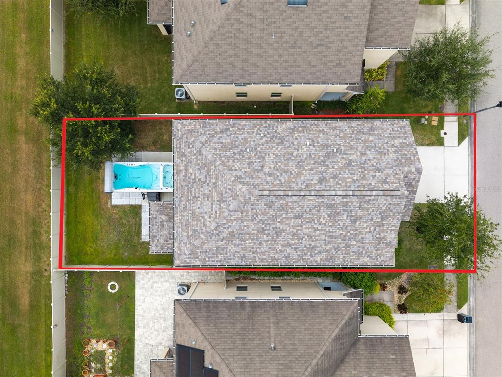 An aerial view shows a house with a backyard pool enclosed by a red border — 5946 81ST AVENUE N, PINELLAS PARK, FL