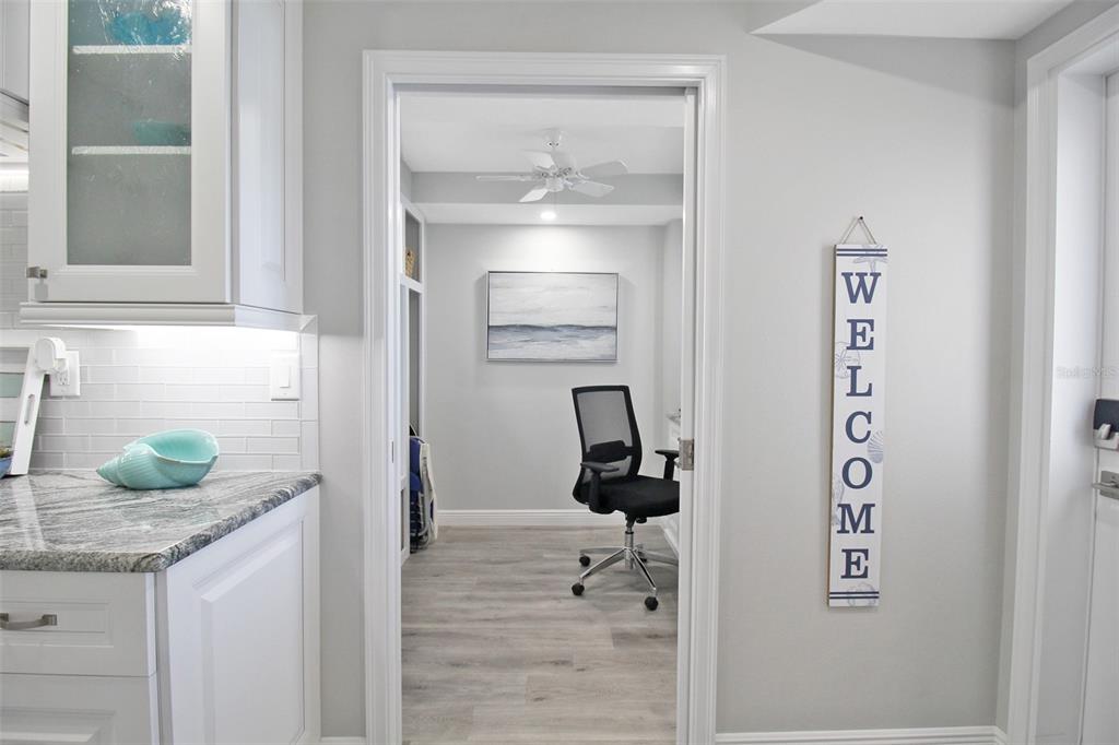 A view from a kitchen into a home office with light flooring and a ceiling fan — 5780 MIDNIGHT PASS ROAD UNIT 609, SARASOTA, FL