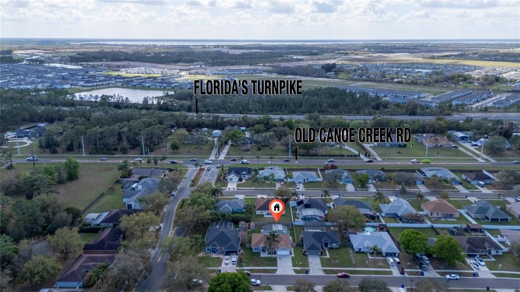 This aerial view shows a residential neighborhood near Old Canoe Creek Road and Florida's Turnpike — 3586 YELLOW BIRD COURT, ST CLOUD, FL