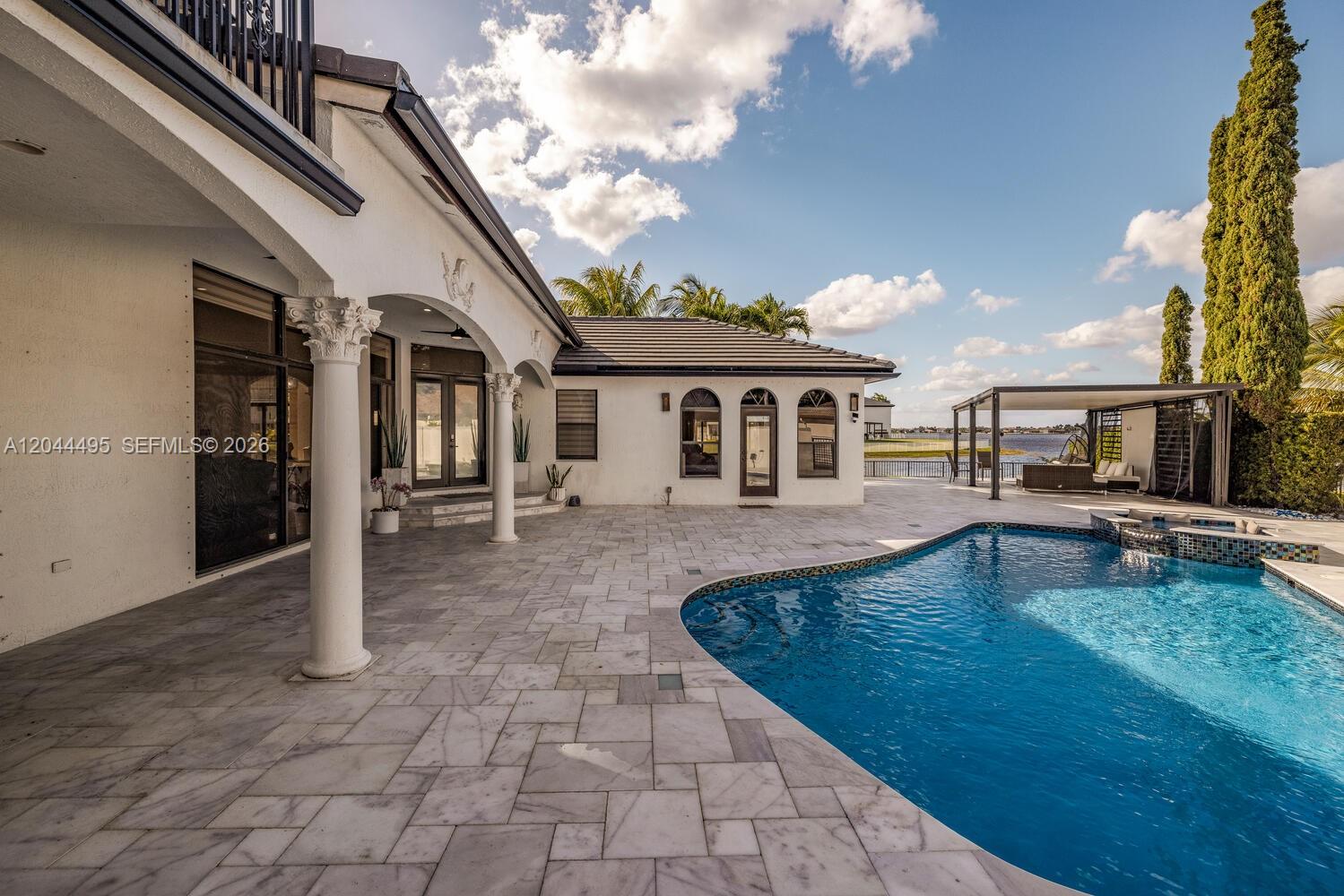 A two-story house with a tiled roof, arched entryway, and a paved driveway — 3910 SW 186th Ter, Miramar FL 33029, MIRAMAR, FL