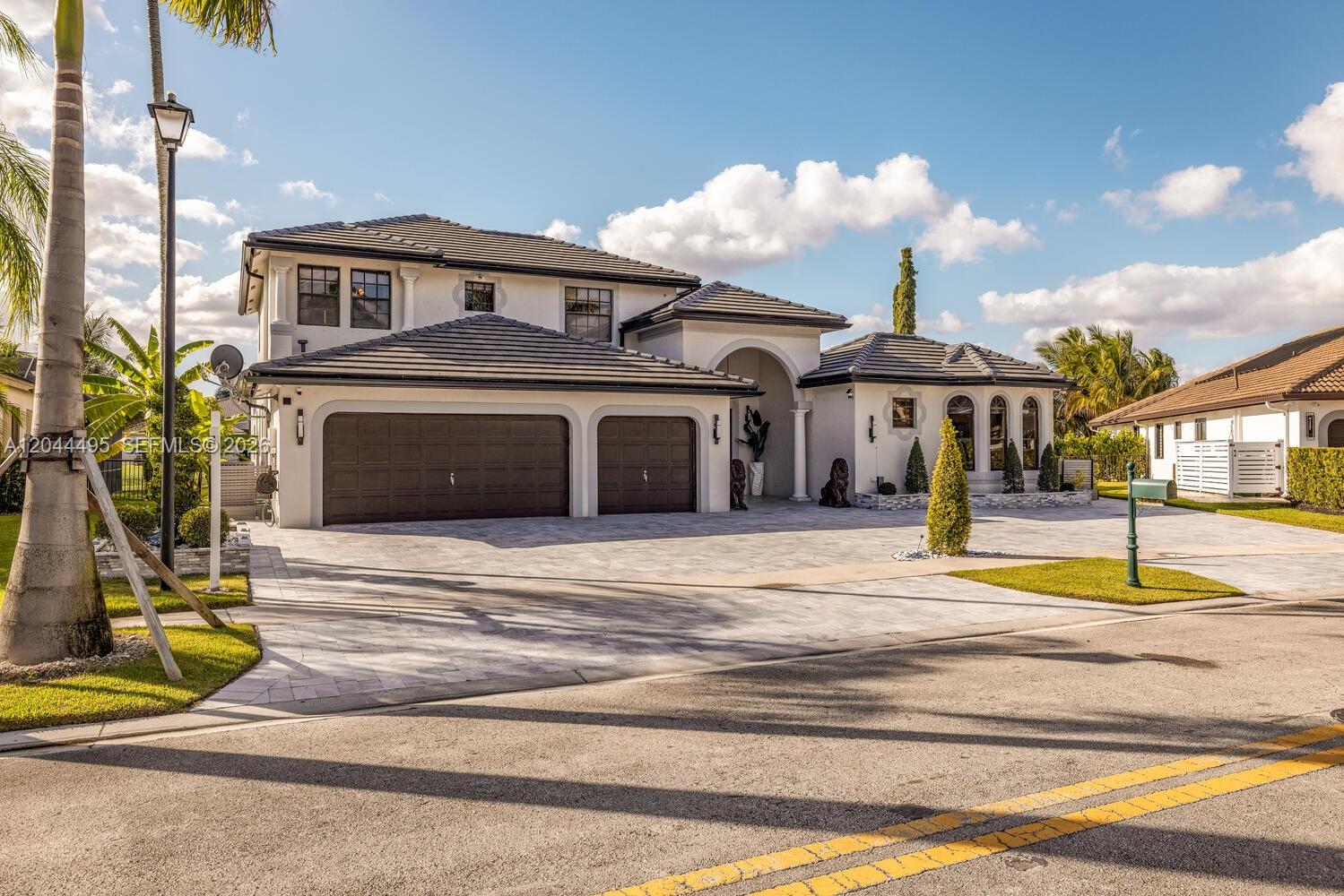 A two-story house with a tiled roof, a three-car garage, and a paved driveway — 3910 SW 186th Ter, Miramar FL 33029, MIRAMAR, FL