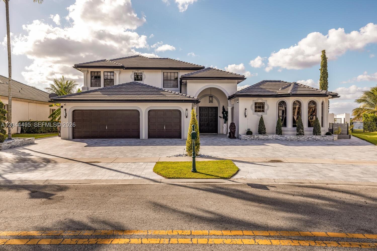 A white house with a covered patio, swimming pool, and lake view — 3910 SW 186th Ter, Miramar FL 33029, MIRAMAR, FL
