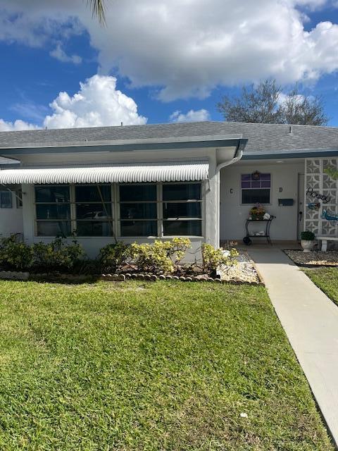 A single-story building exterior features a white awning over large windows and a concrete walkway — 1157 S Drive Circle # C, Delray Beach FL 33445, DELRAY BEACH, FL