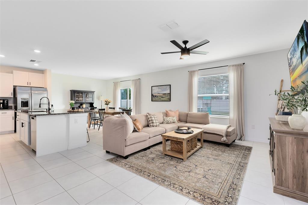 An open-concept living room and kitchen featuring a sectional sofa, area rug, and island — 1791 YELLOW TRAIL, LAKELAND, FL